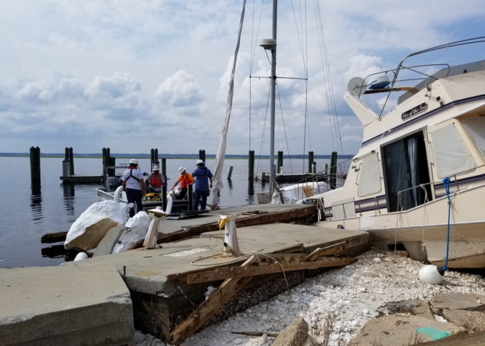 Storm cleanup at a damaged marina.