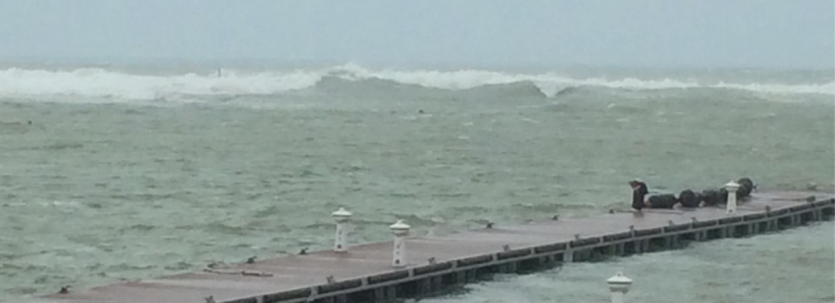 Waves from a typhoon break on the reef protecting Kadena Marina near the U.S. Air Force base in Okinawa, Japan, while the docks stand intact after the storm.